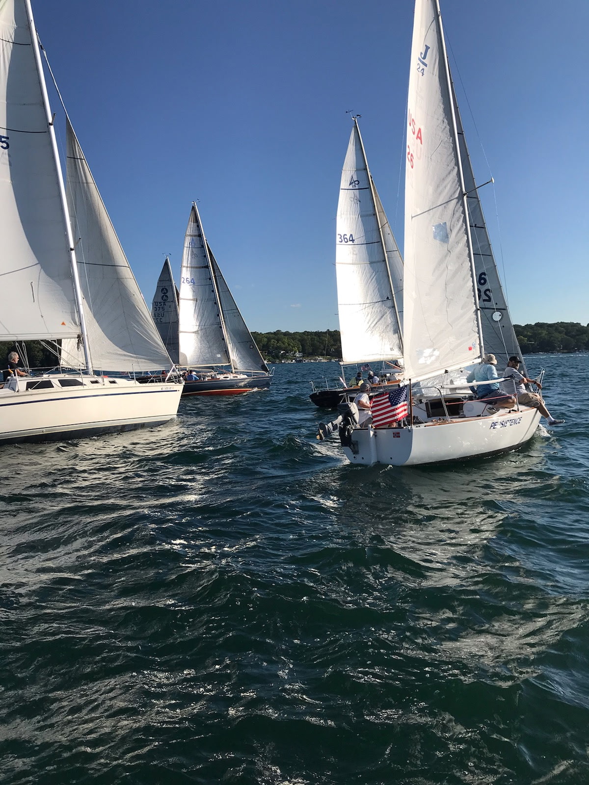GLKC fleet racing with American flag on Geneva Lake